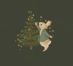 a white rabbit standing next to a christmas tree with gold stars on it's legs