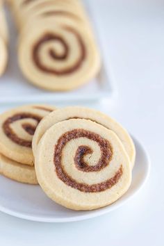 several cookies on a white plate with chocolate swirls