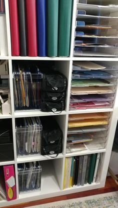 a book shelf filled with lots of books and folders