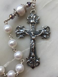 This is a beautiful, wire-wrapped, heirloom single decade rosary! The rosary is handmade with 20 gauge argentium silver wire, sterling silver chain, and Bali sterling silver bead caps. The medals and crucifix are all sterling silver. The beads are 7 and 9mm freshwater pearls. The Rosary is the most excellent form of prayer and the most efficacious means of attaining eternal life. It is the remedy for all our evils, the root of all our blessings. There is no more excellent way of praying.~Pope Le Handmade Silver Rosary For Baptism, Handmade Silver Rosary Bracelet For Wedding, Spiritual Gift Wire Wrapped Rosary, Spiritual Wire Wrapped Rosary As Gift, Handmade Silver Wedding Rosary, Handmade Wedding Rosary With Cross Shape, Holy Art, Decade Rosary, Ruby Beads