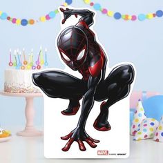 a birthday cake with a spider - man cutout on it