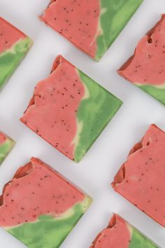 several slices of watermelon and green soap on a white surface with black speckles