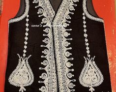 "Here is an Afghan Kuchi Pashtun men handmade zari gold and silver embroidery work vest waistcoat. Traditionally such vests are used on special events like wedding Nikah and Mehndi event. Available in small, medium and large size. It contains very beautiful golden color threads embroidery work which is traditionally called \"Zari or Tilai\" embroidery work. Fabric is long lasting, comfortable and breathable." Traditional Nehru Jacket With Intricate Embroidery, Traditional Sleeveless Nehru Jacket With Intricate Embroidery, Elegant Embroidered Festive Vest, Traditional Festive Vest With Intricate Embroidery, Traditional Sleeveless Vest With Resham Embroidery, Traditional Festive Vest For Eid, Traditional Vest For Eid Festivities, Traditional Sleeveless Vest For Eid, Traditional Black Sleeveless Vest