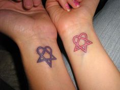 two people with matching tattoos on their arms