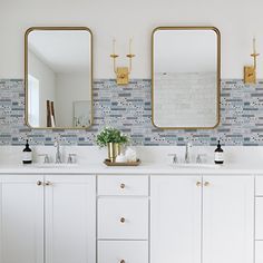 a bathroom with two sinks and three mirrors on the wall next to eachother