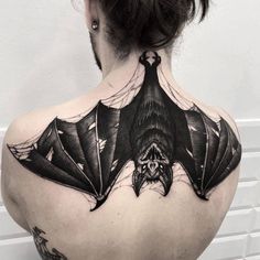 a man with a bat tattoo on his back