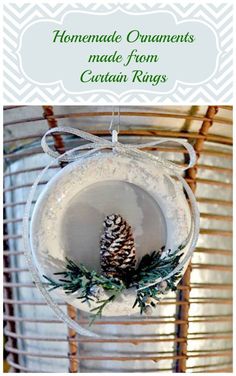 an ornament hanging from the ceiling with a pine cone on it and text overlay that reads homemade ornaments made from curtain rings