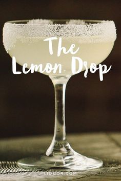 the lemon drop cocktail in a coupe glass on a wooden table with text overlay that reads, the lemon drop