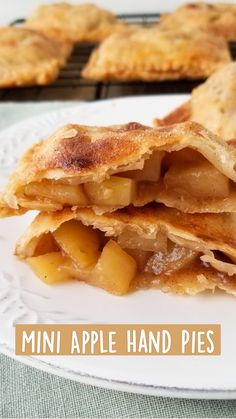 two pieces of apple hand pies on a white plate