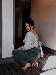 a woman sitting on the floor with her legs crossed