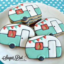 four decorated cookies are sitting on a plate