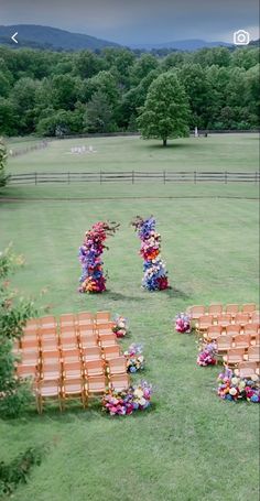 an outdoor ceremony setup with wooden chairs and flowers