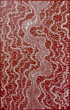 an intricately designed red and white painting on a brown background, with lines in the middle