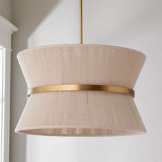 a light fixture hanging from the ceiling in a room with white walls and window sill