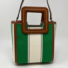 Staud Mini Shirley Bag with Dustbag Retail $295 Designer = Staud Color = Green/White Material = Canvas & Leather Condition = New With Tag Height = 7.5 Width = 8.5 Depth = 4.5" Location: Chicago Item Number: 101-2190 Item ID: 300065 Category: Handle Bag White Bucket Box Bag With Detachable Strap, Green Rectangular Bucket Bag With Detachable Strap, Green Rectangular Bucket Bag With Detachable Handle, White Rectangular Bucket Bag For Shopping, White Rectangular Bucket Bag For Errands, Green Bucket Box Bag For Shopping, White Square Bucket Bag With Removable Pouch, White Rectangular Bucket Bag, Chic Green Rectangular Bucket Bag