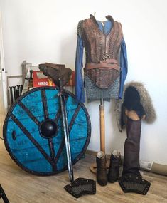 an assortment of medieval clothing on display in a room