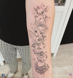 a tattoo on the arm of a woman with an image of tinkerbells