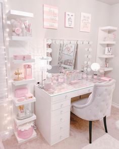 a white desk topped with a mirror and lots of pink items on top of it