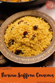 a close up of a plate of food with rice and raisins on it