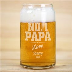 a close up of a beer in a glass on a wooden table with the word class of 2017 printed on it