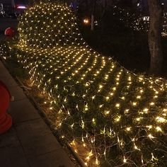 there are lights on the side of this fence and it looks like they're going down the hill