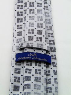 "This silk necktie make a stunning Christmas gift for anyone. Also makes a great wedding necktie. Features a silver background with a gray geometric pattern. Also available as a extra long Necktie. Handmade from 100% silk, this special collection features a .75\" Eds Neckties logo at the bottom right front corner of every tie and a larger logo located on the tipping (Back of the tie). The label features the collection name (Nathaniel Alexandria) Named after my son Nathaniel and my daughter Alexa Purple Gothic, Make A Tie, Silver Background, Tie Men's, Goth Wedding, Stripe Silk, Silk Necktie, Wedding Ties, Gold Stripes