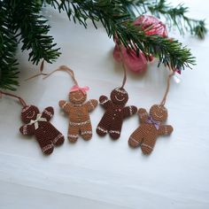 three ornaments are hanging from a christmas tree