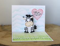 a card with a zebra holding a heart on it's chest and the words i love you just the way