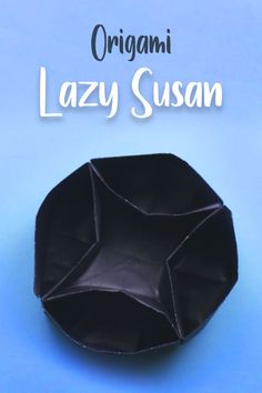 an origami lazy susan sitting on top of a blue surface with the title