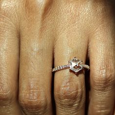 a woman's hand with a diamond ring on it