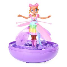 a doll is standing on top of a purple bowl