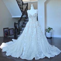 a wedding dress on display in front of stairs