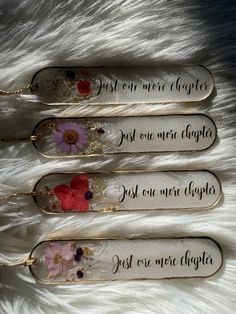 three metal key chains with flowers on them