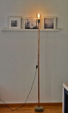 a lamp that is sitting on top of a wooden floor next to a microwave oven