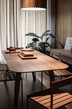 a wooden table sitting in front of a window