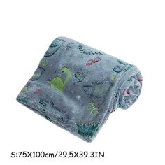 an image of a baby blanket with dinosaurs on it