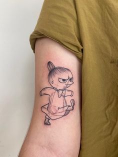 a person with a small tattoo on their arm that has an image of a cartoon character