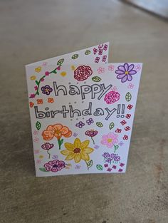 a happy birthday card with flowers on it