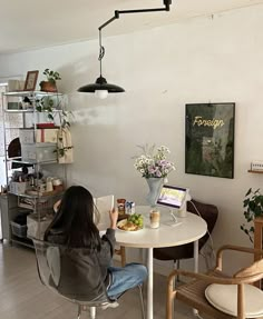 a woman sitting at a table with food in front of her