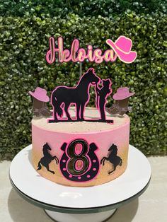 a pink and black horse birthday cake with the number eight on it's side