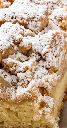 a close up of a piece of cake on a plate with powdered sugar topping