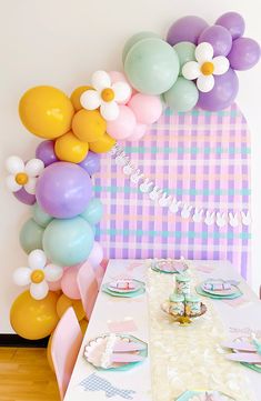 a table with balloons and plates on it