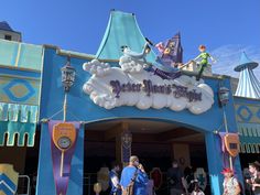 people are standing in front of the entrance to mickey's magic kingdom