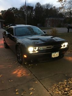 a black car is parked on the street