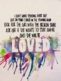 the words loved are painted on top of watercolor paint splatters in different colors