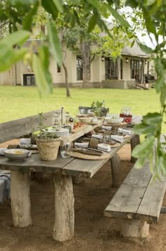 a picnic table set up with plates and utensils