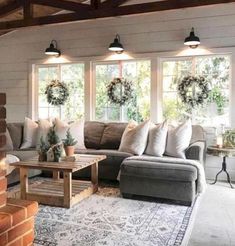 a living room filled with furniture and windows covered in wreaths on top of them