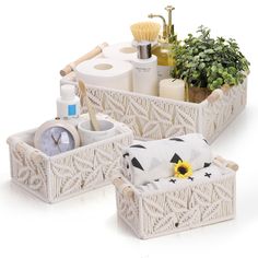 two white baskets filled with toiletries next to each other