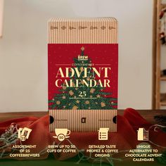 an advertise calendar with christmas trees and presents on the table next to it