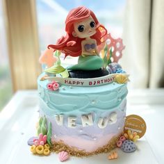 a birthday cake with a little mermaid on top